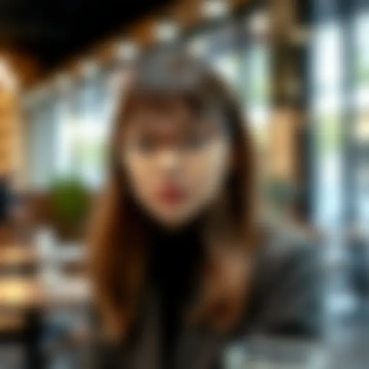 A fashionable individual wearing clear glasses with tortoiseshell rims in a trendy café setting.