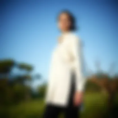 Elegant long shirt with side slits showcased in a natural setting