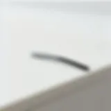 A close-up view of a sleek minimal hair clip placed on a smooth surface.