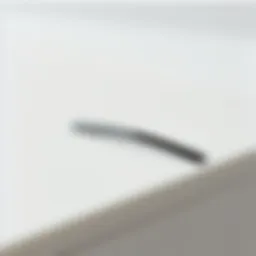 A close-up view of a sleek minimal hair clip placed on a smooth surface.