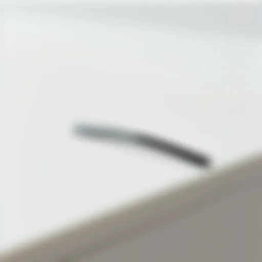 A close-up view of a sleek minimal hair clip placed on a smooth surface.