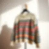 Elegant display of a striped drop shoulder sweater on a minimalist background