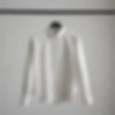 Elegant white statement blouse displayed on a hanger in a contemporary wardrobe