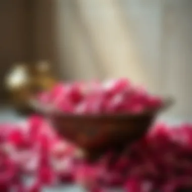 An antique bowl filled with rose petals and essential oils